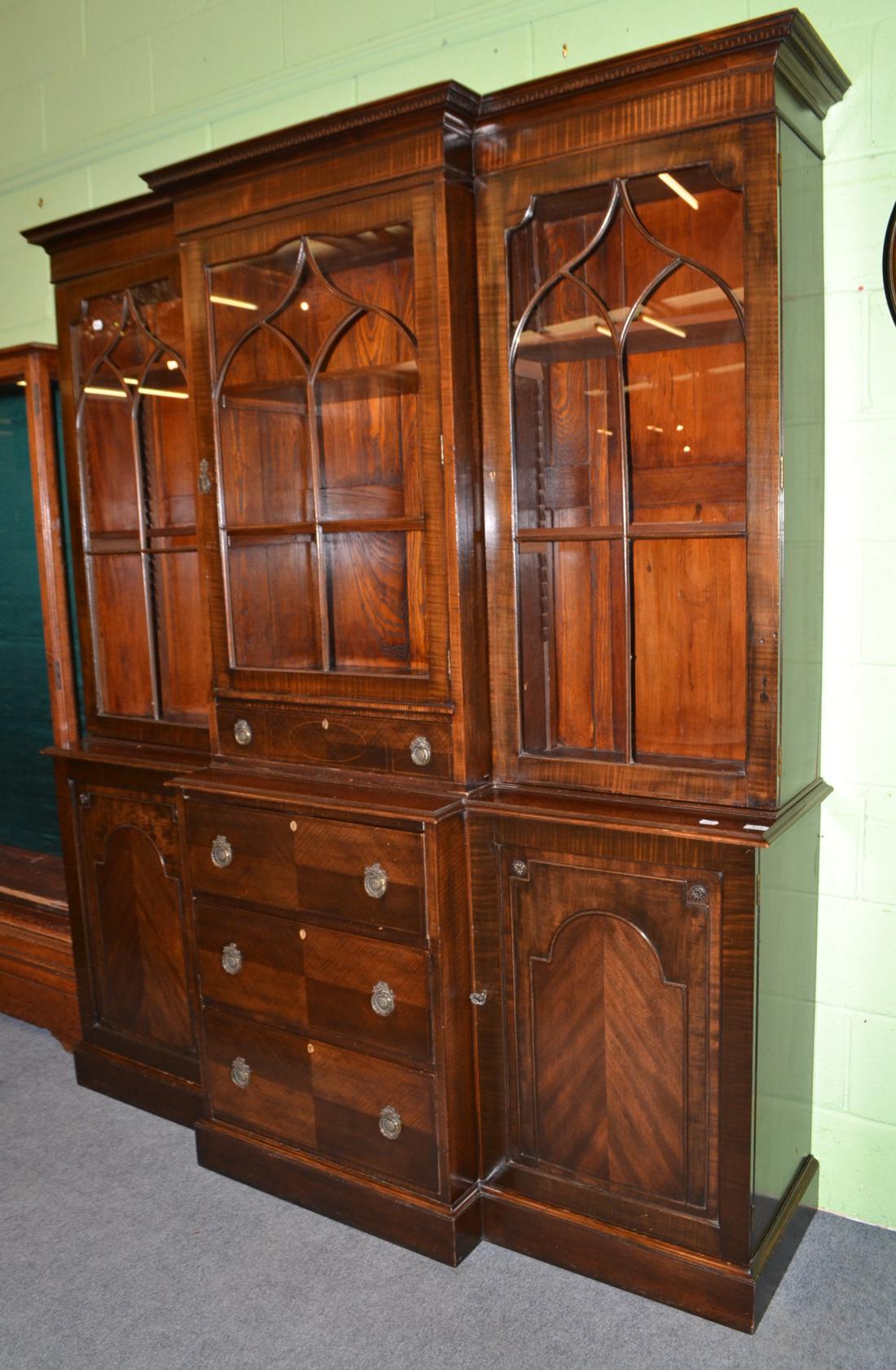 A mahogany break front bookcase