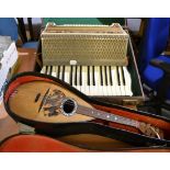 A cased mandolin and a cased Hohner Verdi II piano accordion