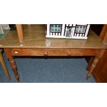 A pine kitchen table fitted with a single drawer