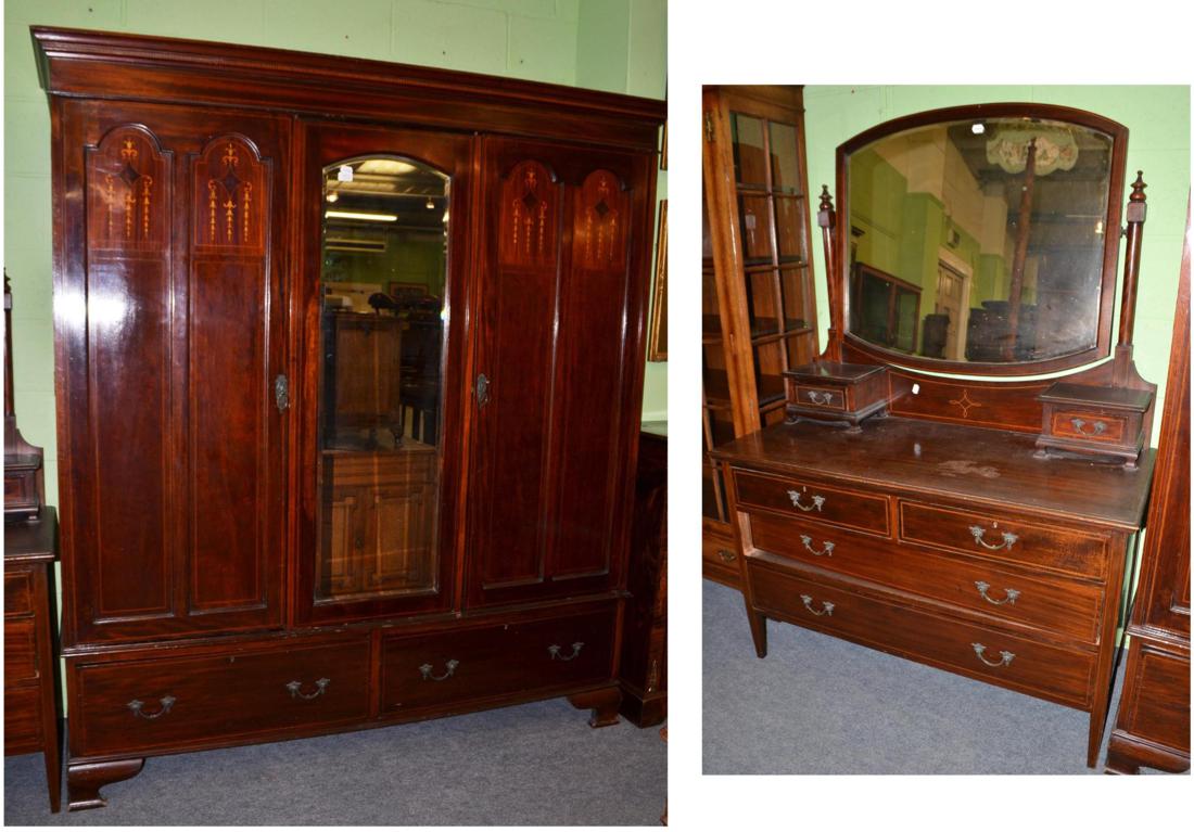 An Edwardian mahogany triple door wardrobe and matching dressing table