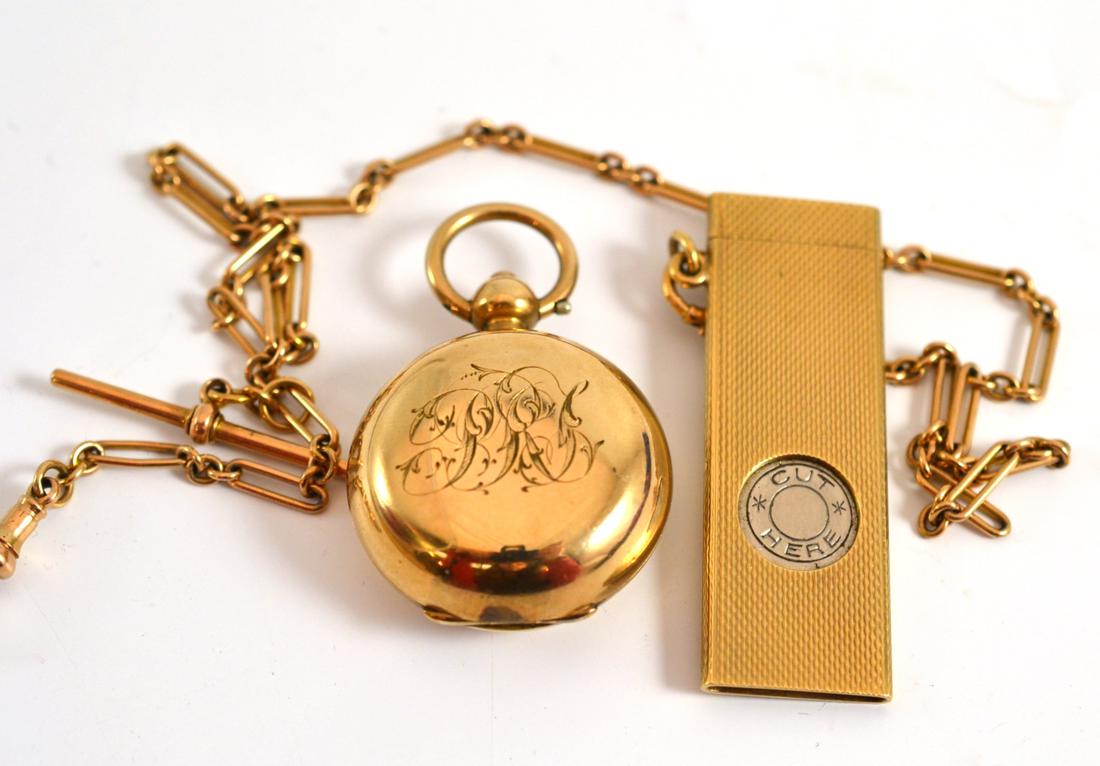 A 9ct gold cigar cutter attached to a 9ct gold albertina chain, also a gold filled sovereign case