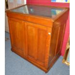 An oak display case with hinged lid and velvet interior