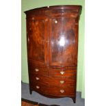 A Regency style mahogany and ebony strung bow fronted linen press