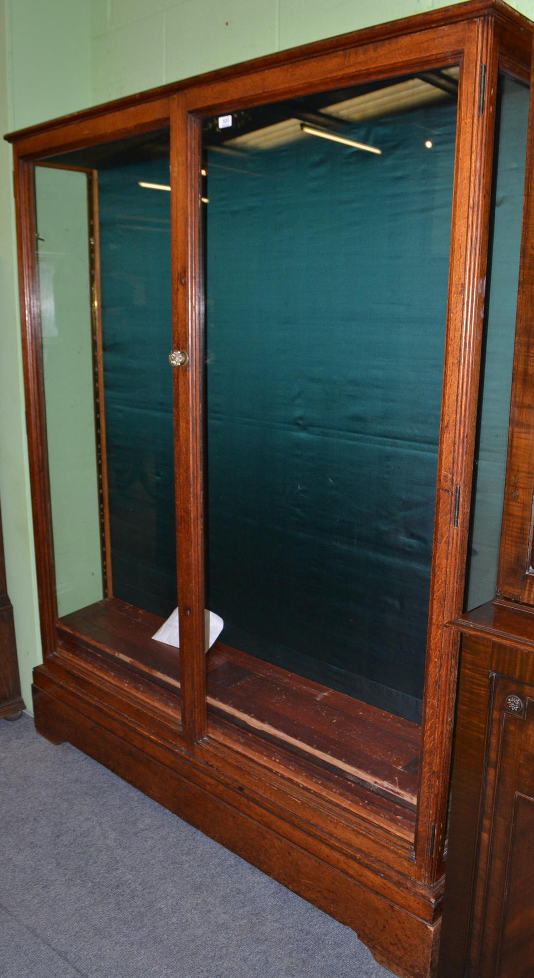 A Victorian glazed oak display/gun cabinet stamped 'Holland & Sons'