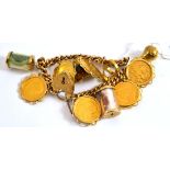 A charm bracelet, stamped '9.375', hung with six loose mounted half sovereigns (1904, 1898, two