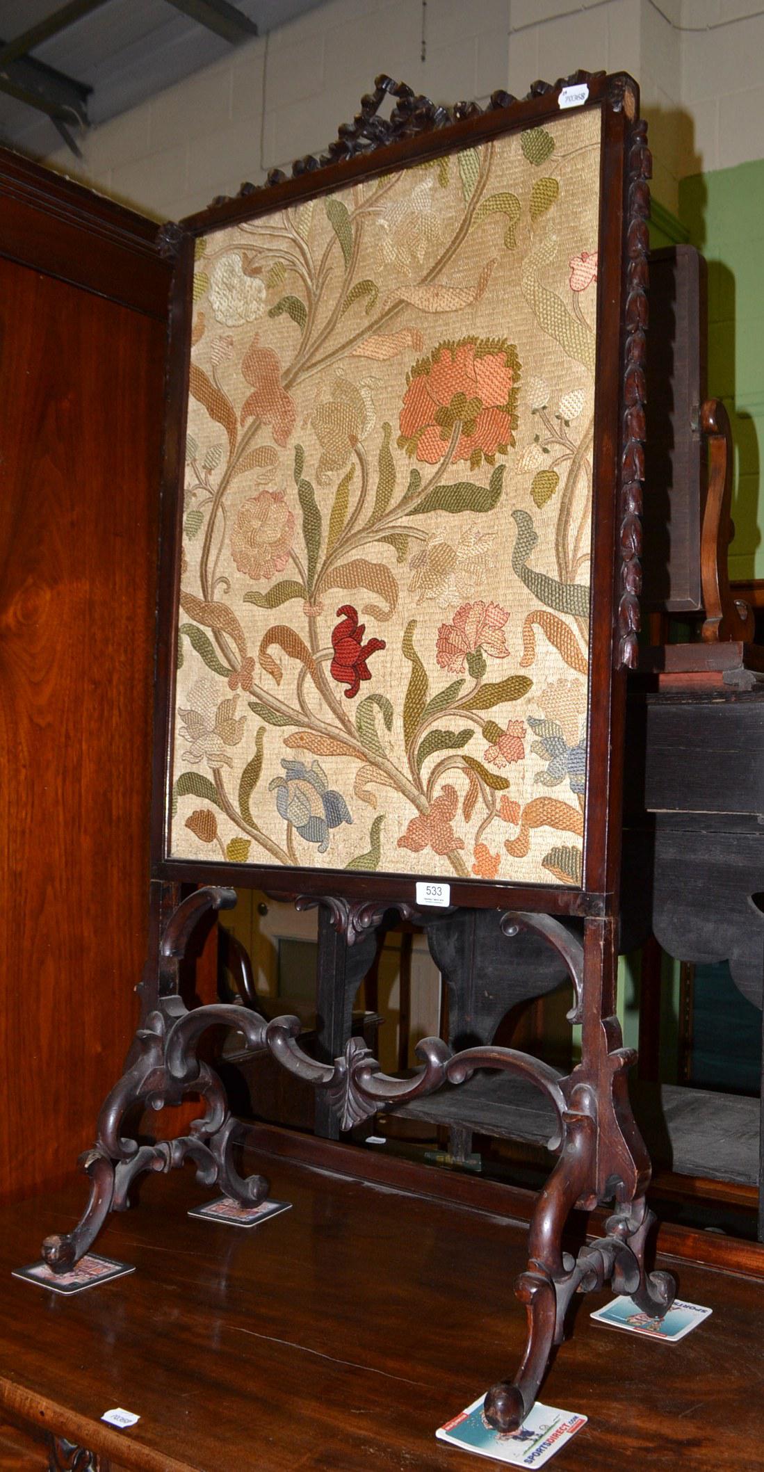 A Victorian carved hardwood fire screen