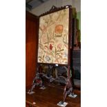 A Victorian carved hardwood fire screen