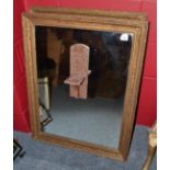 A pair of gilt framed mirrors with candle stands