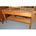 An oak two tier draper's shop table with single drawer