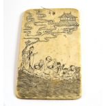 A Japanese carved ivory tablet, one side with figures on a boat, the other with Japanese characters,