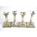 A pair of silver Corinthian column candlesticks and a pair of plated candlesticks en suite (4)