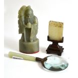 A Chinese carved soapstone seal, a carved hardstone plaque and a magnifying glass