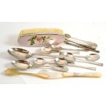 A collection of silver spoons, sugar tongs, swizzle stick, mother-of-pearl knife and spoon, etc