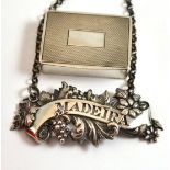 A silver snuff box and a 'Madeira' wine label