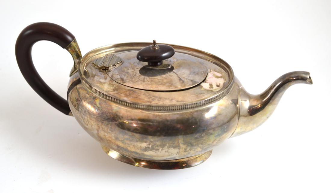 A silver teapot with a wooden handle, Adie Brothers, Birmingham 1948