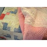 Pink reversible quilt with pale pink border, 200cm x 235cm and a patchwork quilt with later blue