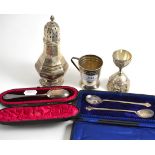 A silver sugar caster Birmingham 1931, an Indian silver double egg cup, a Christening mug and two