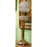 A brass Corinthian column oil lamp with cut glass font