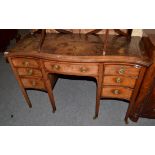 An Edwardian mahogany serpentine shaped desk