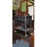 A late Victorian carved oak writing table, two drawer chest and a Victorian mirror