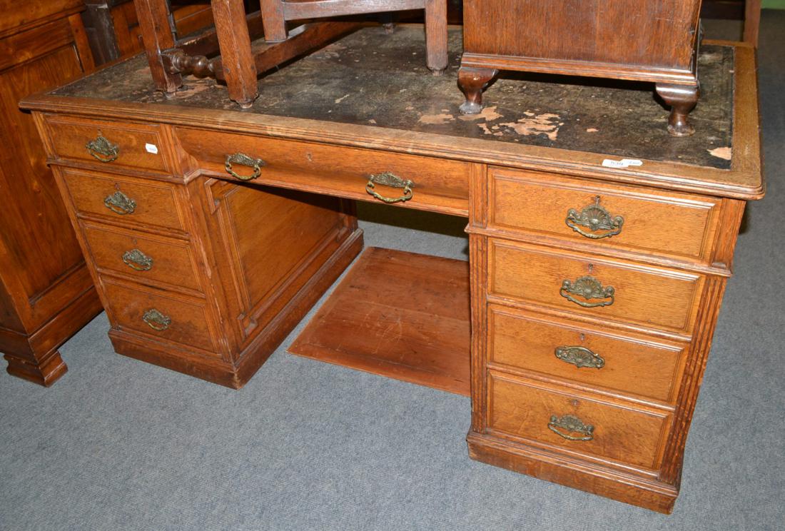 A late Victorian oak double pedestal desk with Hobbs & Co brass locks