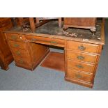 A late Victorian oak double pedestal desk with Hobbs & Co brass locks