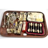 A tray including Scottish silver sugar tongs, silver cased spoons, silver and enamelled spoons, etc