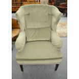 A George III style wing back armchair re-covered in green velvet