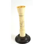 A Japanese carved ivory and bone candlestick on a turned wooden base, circa 1920