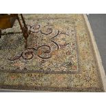 A Kashmir silk rug, North West India, the ivory field of scrolling serrated leaves around a