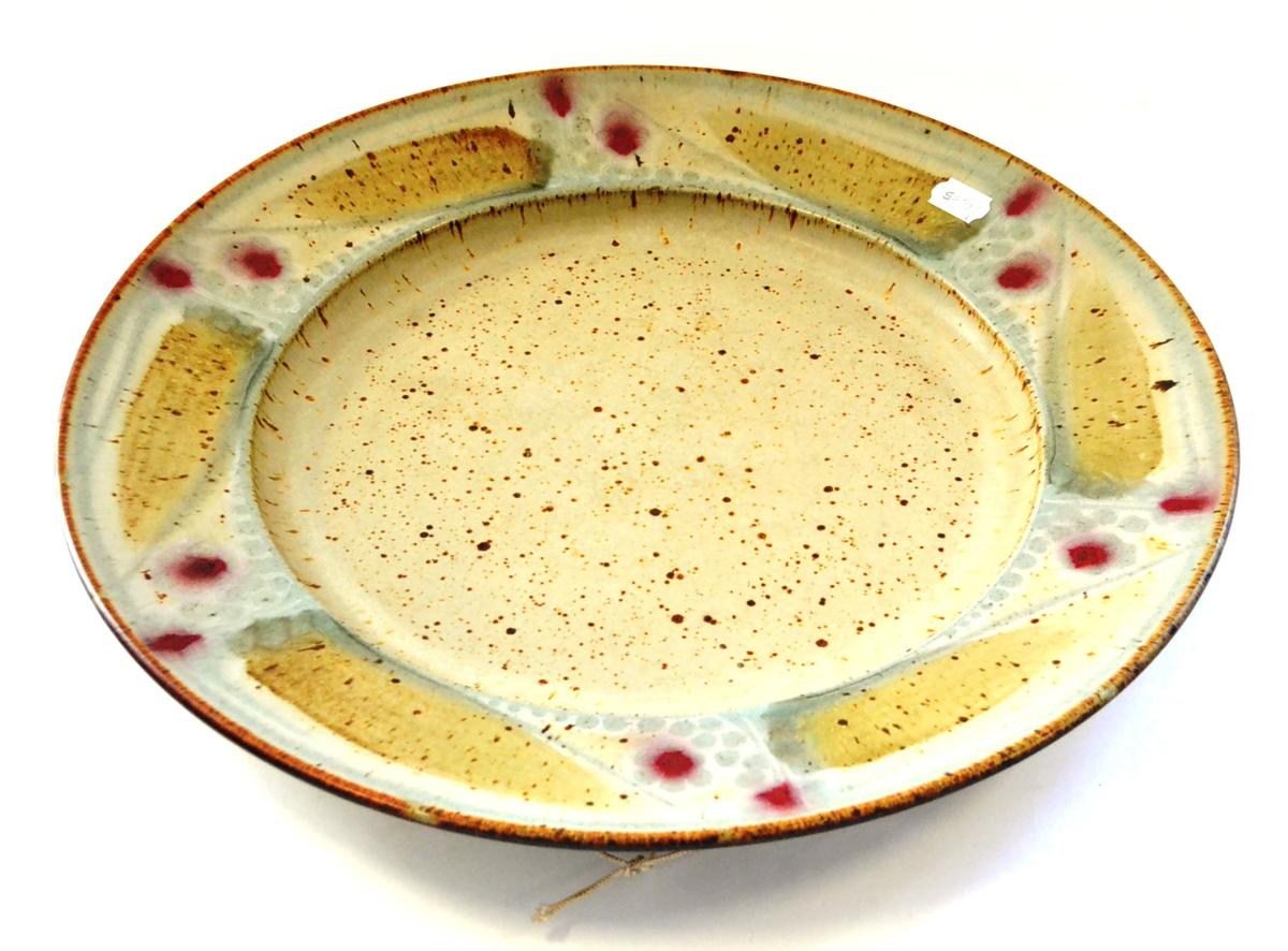 David Lloyd Jones (1928-1994): A Stoneware Charger, with a repeating pattern on a speckled ground,
