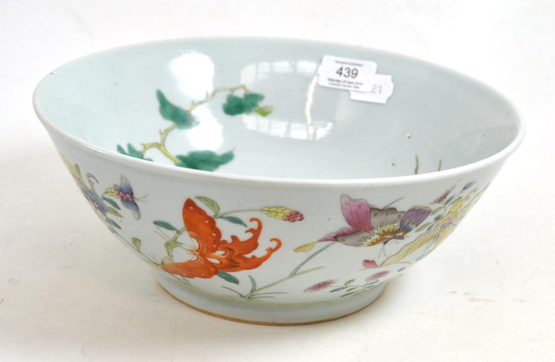 A Chinese porcelain bowl, painted in famille rose enamels with butterflies amongst foliage, bears