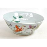 A Chinese porcelain bowl, painted in famille rose enamels with butterflies amongst foliage, bears