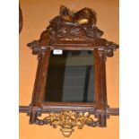 A late Victorian gilt and faux tortoiseshell wall mirror, the cresting as Britannia holding a shield