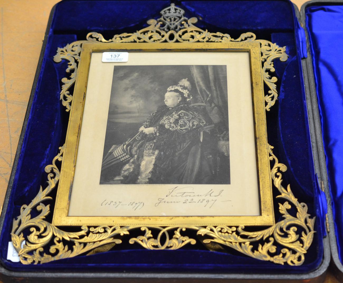 A presentation frame containing a print of Queen Victoria which bears a printed facsimile of Queen