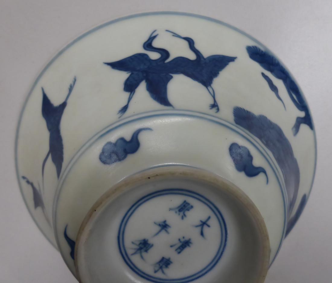 A Chinese porcelain bowl, decorated with four cranes flying amidst clouds and pine trees, bears - Image 5 of 7