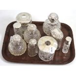 Nine late Victorian/Edwardian silver topped and cut glass scent bottles
