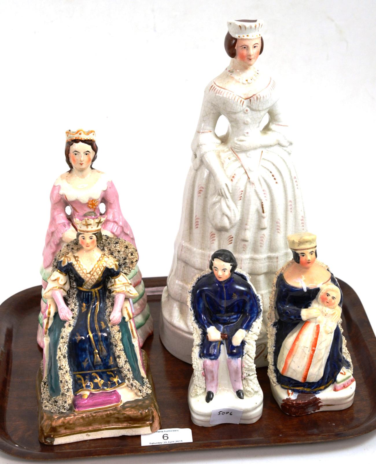 A Staffordshire pottery figure of Queen Victoria, circa 1840, in ceremonial robes sitting in a
