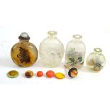 An agate snuff bottle, three interior painted glass snuff bottles and a quantity of stoppers
