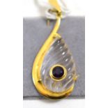 An 18ct gold rock crystal and amethyst pendant, a teardrop carved rock crystal within a yellow