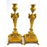 Pair of late 19th century gilt bronze candlesticks on paw feet, with nozzles, 37cm high Some