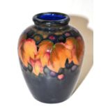 A Walter Moorcroft Leaf and Grape pattern baluster vase, on a blue ground, impressed factory marks