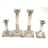Two pairs of silver candlesticks  Lots of dents to bases, look pretty but upon close inspection in