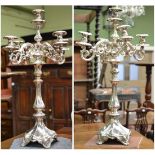 A pair of imposing candelabra, stamped 84, the scroll branches supported on a square base with