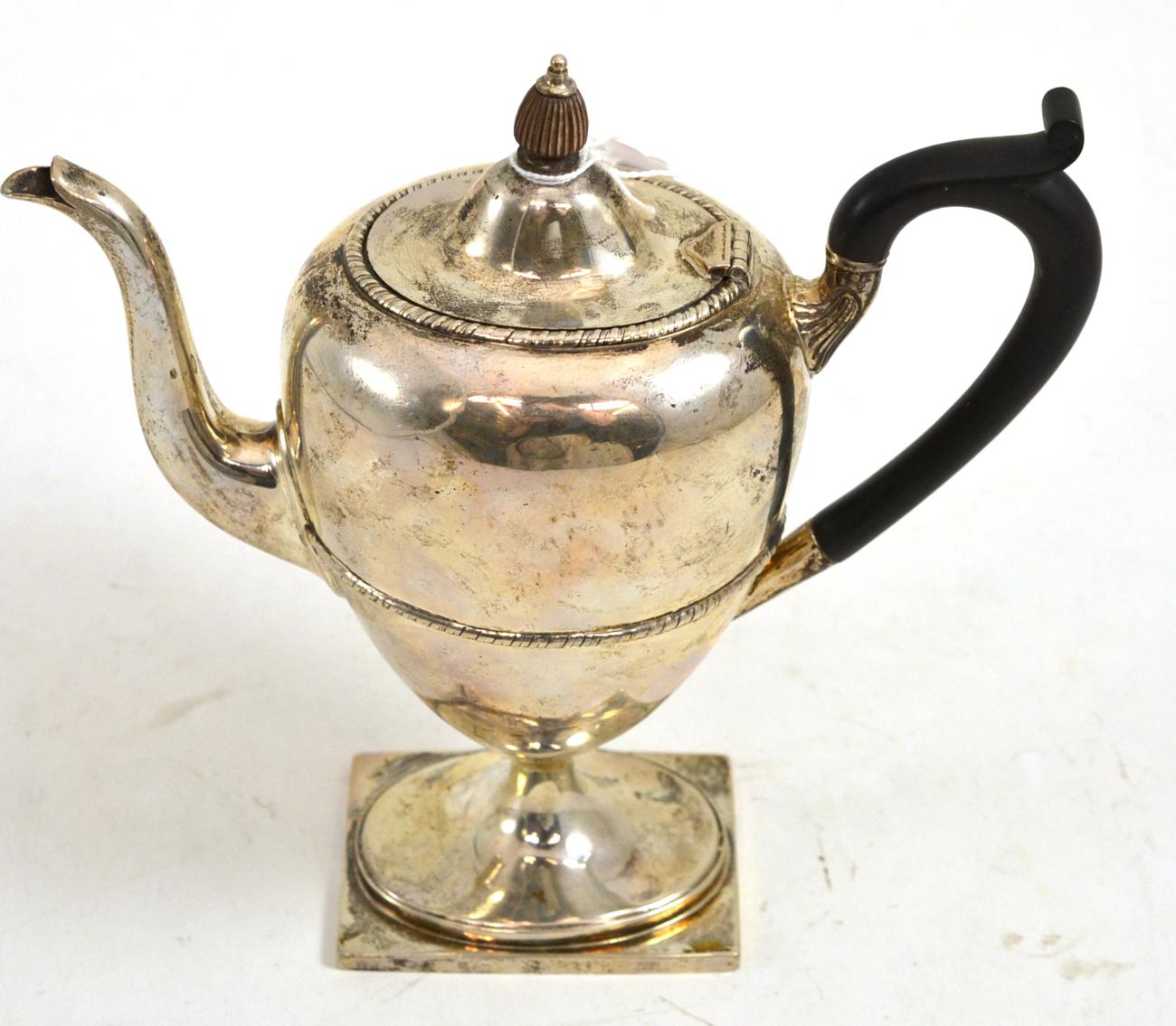 A George V silver coffee pot and hinged cover, Sheffield 1910, of urn shape, engraved with a swag