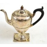 A George V silver coffee pot and hinged cover, Sheffield 1910, of urn shape, engraved with a swag