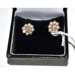 A pair of diamond and split pearl earrings, an old cut diamond within a border of split pearls, in