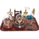 Seven watch stands, comprising a painted metal ostrich stand, night lamp stand, blue glass and
