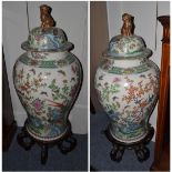 A pair of Chinese porcelain baluster jars and covers, in 18th century style, painted in famille rose