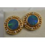 A pair of opal doublet and diamond earrings, the round opal triplet in a yellow collet setting, to a
